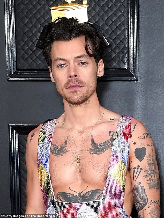 As he was: Harry's fans have a meltdown amid claims he has shaved off his famous locks (pictured in February)