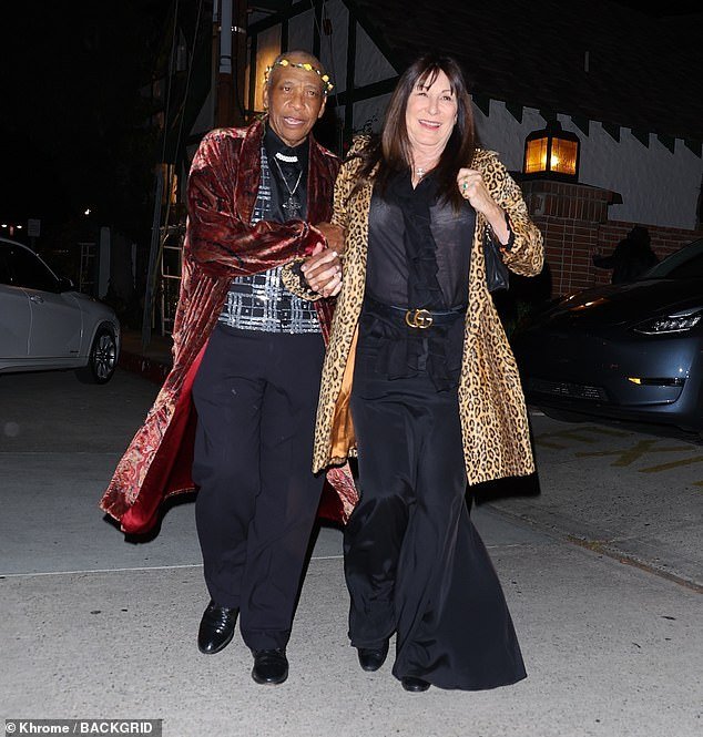 Icon: Anjelica wore a stylish leopard print coat for the evening