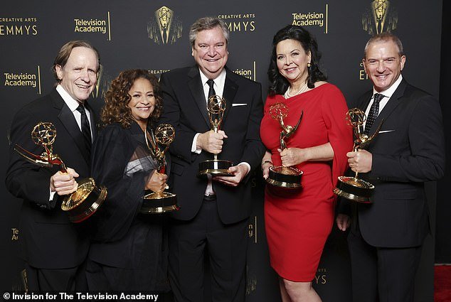 Haskell Sr.  (center) appears at the September 2021 Emmy Awards, winning Outstanding Television Movie for 'Dolly Parton's Christmas on the Square'