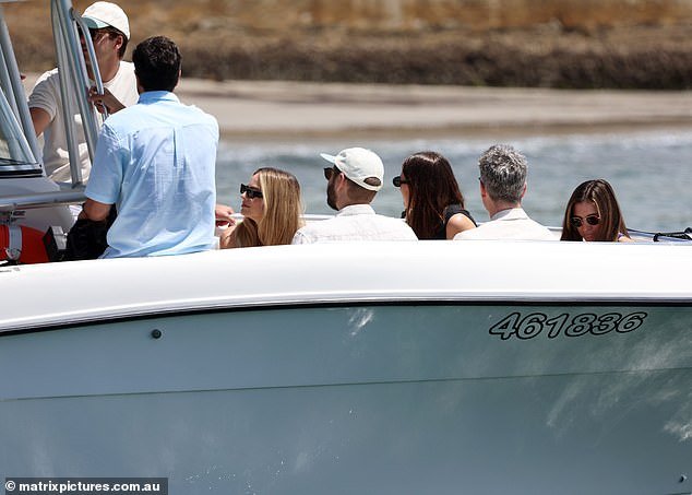 The group seemed to be chatting and enjoying themselves on the boat