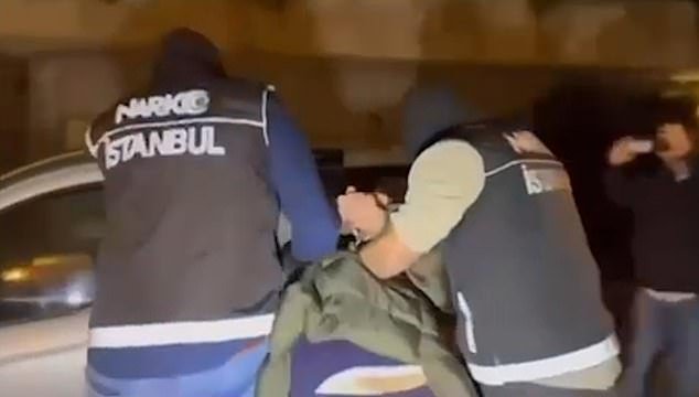 Dramatic images showed the man being held by armed Turkish police