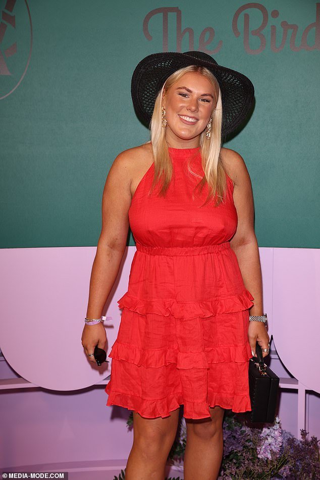 Brooke Warne went for something more casual with a short red halter dress