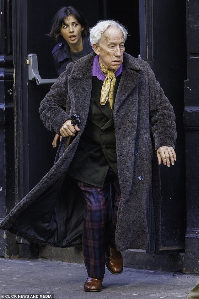 Old style: And Simon, 74, wore an animated blue top hat, with a faux fur coat, a three-piece suit and a walking stick