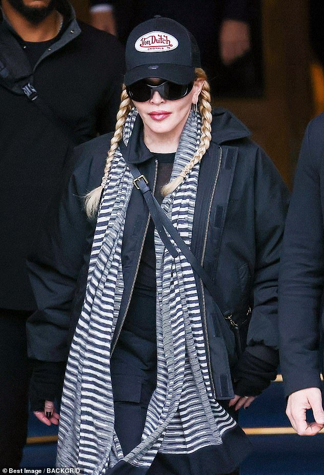 Youthful: She showed off her smooth skin as she stepped out wearing a black cap and dark sunglasses