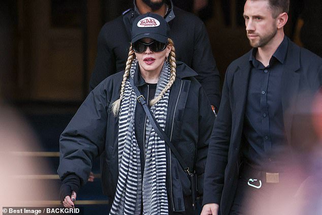 Outfit: Madonna accessorized her look with a full-body leather bag and wore her blonde locks in braids