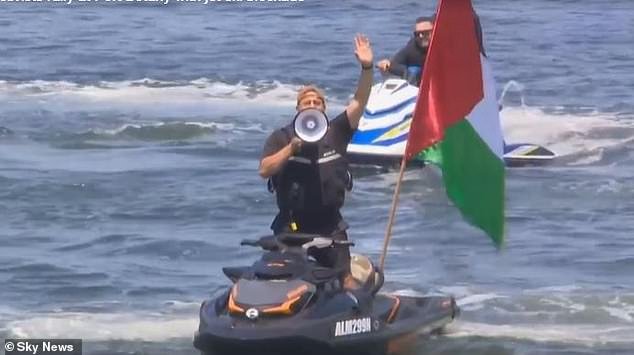 A flotilla of flag-waving pro-Palestinian protesters in boats and skidoos besieged the 13,000-ton cargo ship Contship Dax as it approached the container terminal for docking and unloading