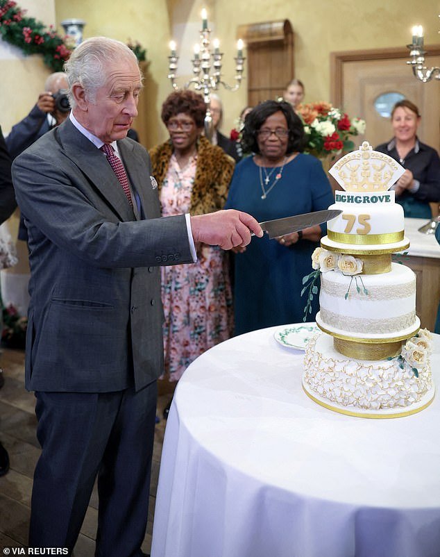 King Charles III cuts his cake as he attends his 75th birthday party hosted by the Prince's Foundation at Highgrove House