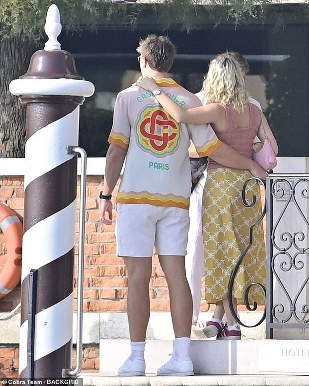 Cute: Daniel and his girl put their arms around each other, and the back of Daniel's shirt said 