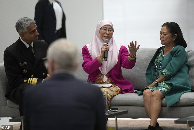 Malaysian First Lady Wan Azizah Wan Ismail, center, speaks between Surgeon General Dr.  Vivek Murthy, left, Philippine first lady Louise Araneta-Marcos, right, and Apple CEO Tim Cook, foreground, during a discussion on mental health