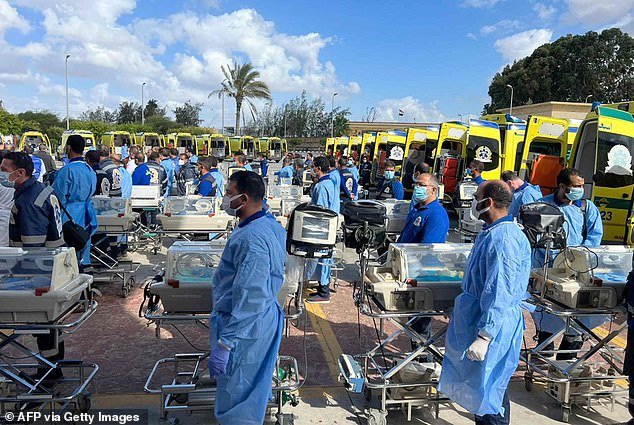 Under the watchful eyes of the UN and the Israeli army, a fleet of ambulances can be seen carrying out the crucial operation across the border at Rafa to hospitals in Egypt.