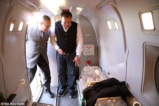 Egypt's Health Minister Khaled Abdel Ghaffar stands next to North Sinai Governor Major General Mohamed Abdel-Fadel Shousha as they look at a premature Palestinian baby evacuated from Gaza