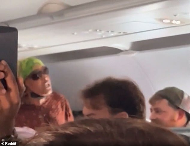 A woman wearing sunglasses stood up from her seat and threatened to fight her 