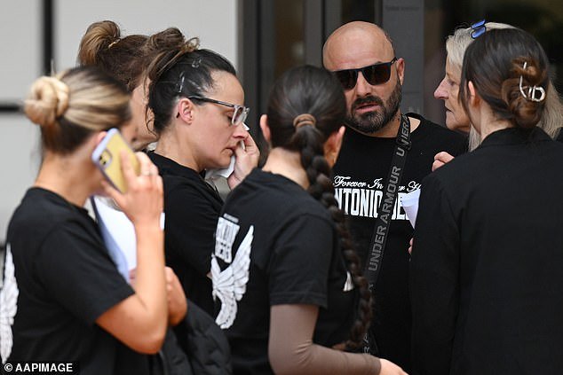 Exaven Desisto (center right), the father of Antonio Desisto, one of the victims of the Buxton car crash that killed five teenagers, leaves with family and friends wearing T-shirts with the name Antonio