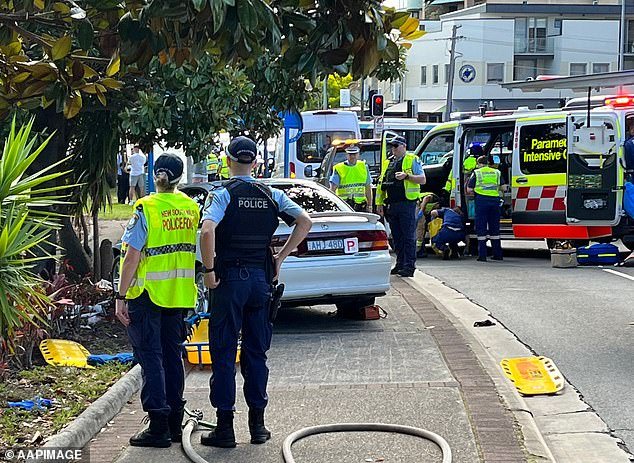 Police Rescue Squad officers freed the boy after 40 minutes and he was taken to Sydney Children's Hospital in a serious condition (photo, emergency services on scene)