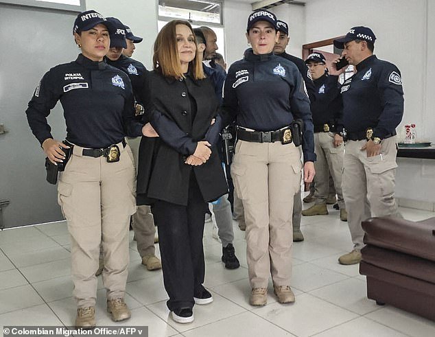 Colombian fashion designer Nancy Gonzalez, 78, is seen grinning at the camera as she is extradited at Bogota's El Dorado International Airport back to the United States