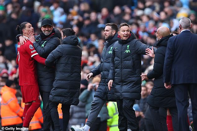 Nunez (left) and Pep Guardiola (second right) were stuck in a queue after the match with the player having to be dragged away by his manager Jurgen Klopp