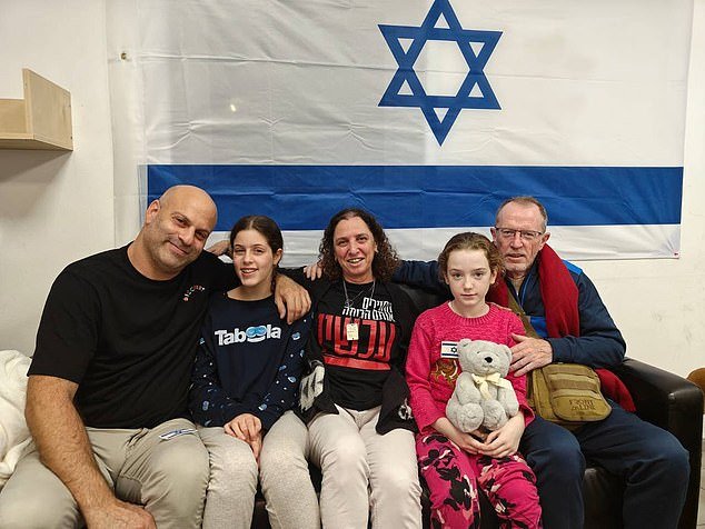 Emily is reunited with her father, while Hila Rotem (second from left), whose mother is still held hostage, reunites with a family member