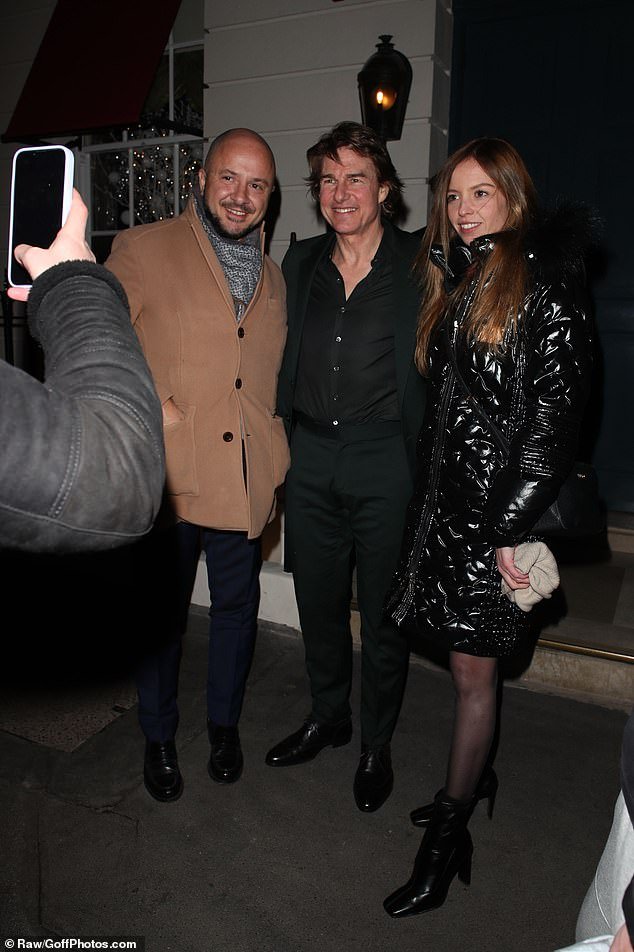 Tom Cruise poses with tourists outside the Mayfair restaurant.  The actor took a lot of time for his fans