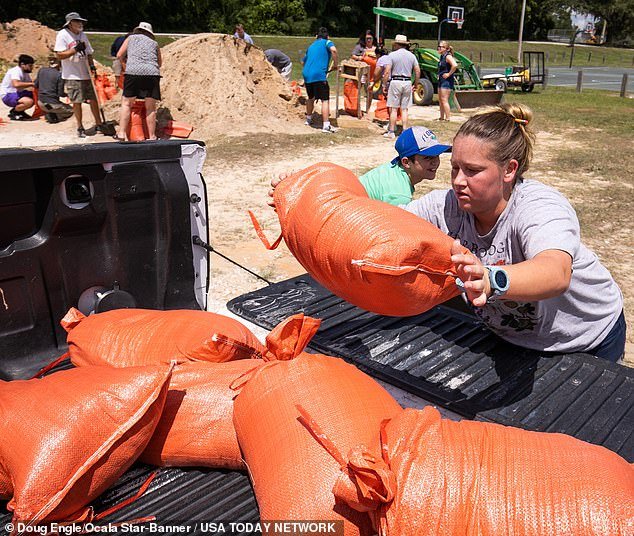Families in Bellview, Florida fill sandbags ahead of Tropical Storm Idalia in August 2023