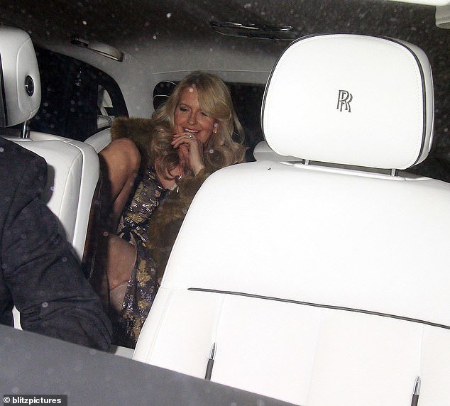 Penny seemed in good spirits as she sat beaming in the back of the car as the couple drove home
