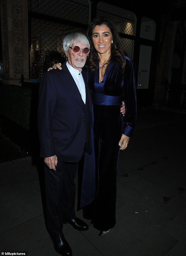 The former Formula One Group CEO, dressed in a navy blue suit, posed next to his wife Fabiana, 46.