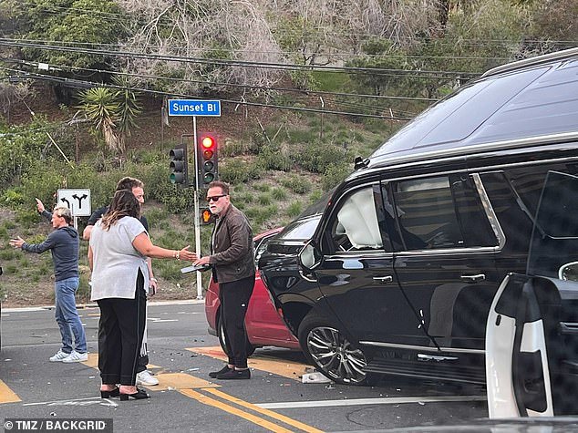 Schwarzenegger is seen next to his SUV after a crash in January this year.  Today a lawsuit was filed against him by plaintiff Cheryl Augustine