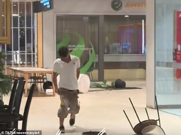 The 23-year-old was seen throwing tables, chairs and potted plants at the shopping center on Jacobs Street in Bankstown at around 9.30pm on Friday.