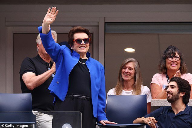 Billie Jean King rises from her seat on a court at the tennis court named after her