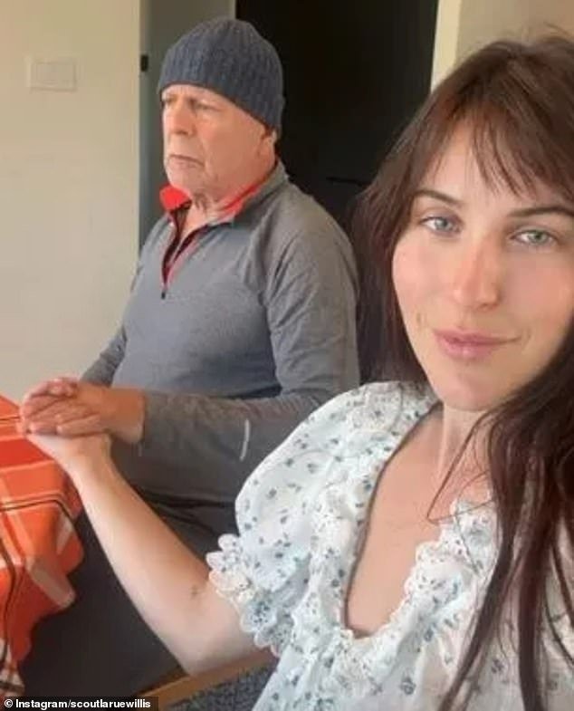 Family time: Bruce Willis, 68, held tightly the hand of his daughter Scout Willis, 32, while spending Thanksgiving with his entire blended family on Thursday