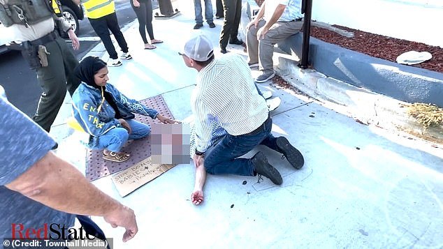 A female Palestinian supporter appears to help Kessler as he lay stricken on the sidewalk.  He died in hospital the next day