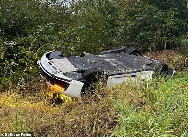 Pictured: The white sports car, believed to be driven by the Chinese woman, overturned and crashed after the collision