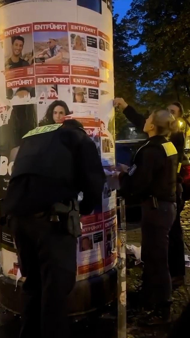The officers reportedly removed the posters without anyone asking them to do so, a move that has angered many