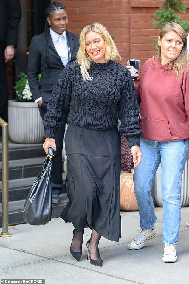 See-through: Hilary Duff emerged from her Manhattan hotel on Thursday wearing a black, tea-length skirt that was so sheer that her panties underneath were visible