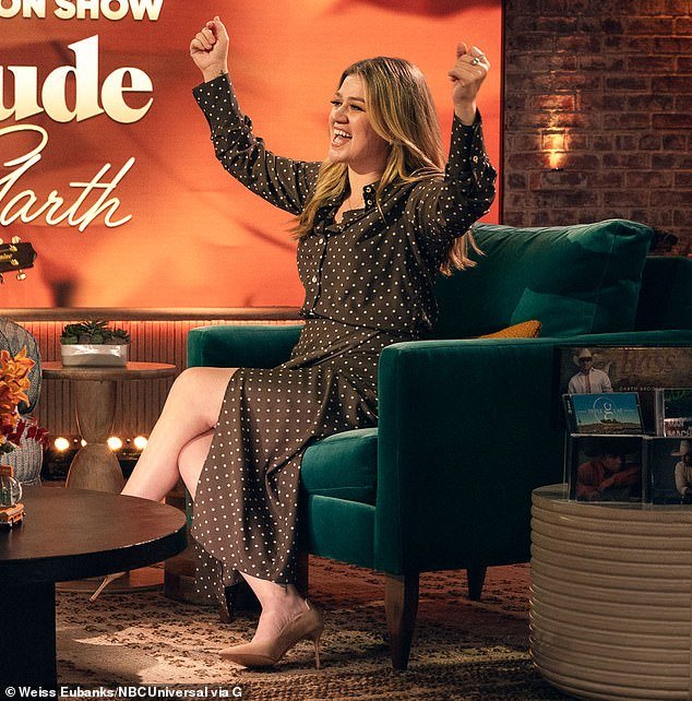 Leggy lady: Kelly Clarkson has come a long way in her weight-loss plan, and she proved it again during her talk show on Monday.  The 41-year-old American Idol veteran showed off her bare legs in a sexy brown and white dress with polka dot buttons and a front slit