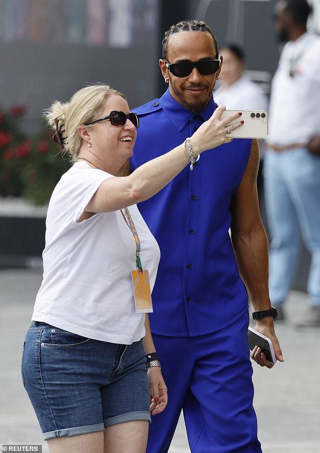 Smile: Lewis Hamilton showed off his unique sense of style on Thursday when a fan took a cheeky selfie ahead of his final run at the Abu Dhabi Grand Prix