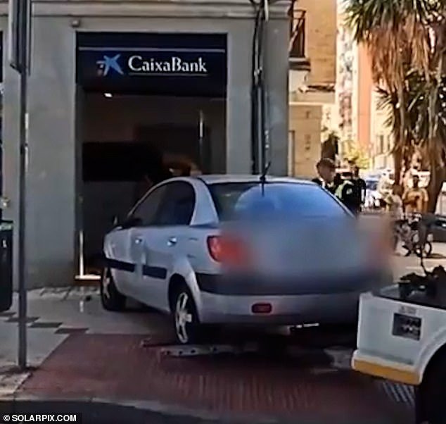 Video shows the family car driving into the popular Spanish bank in Malaga, Spain