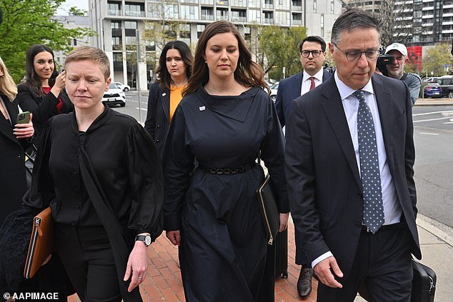 In August 2021, Bruce Lehrmann was charged with rape following allegations that he sexually assaulted Brittany Higgins (pictured, center, outside court).  He denied the allegations