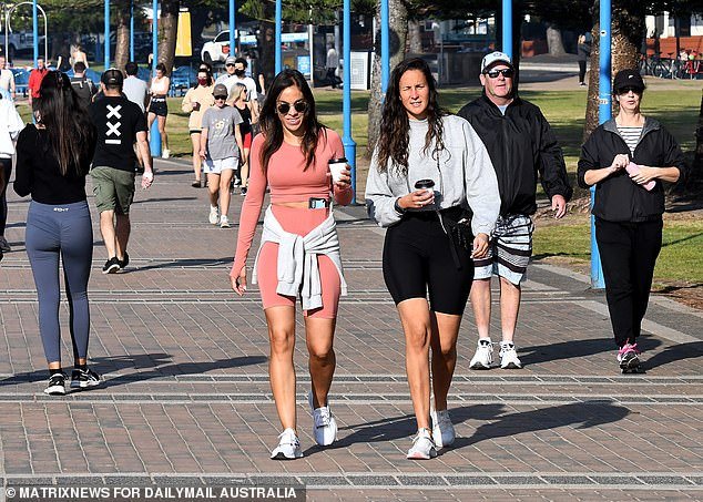 Delaying the rate hike on Melbourne Cup Day would have raised the risk of interest rates rising more aggressively in coming months, Reserve Bank minutes show, but more rises could follow.  People are pictured walking in Coogee in Sydney's east