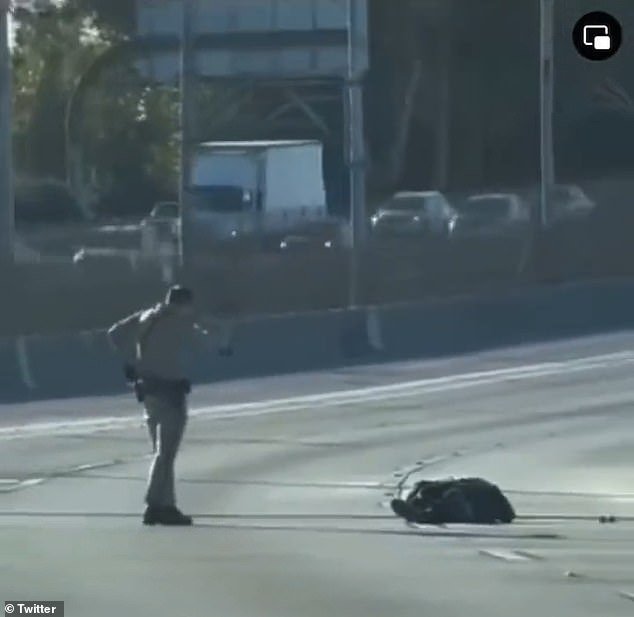 The officer is seen shooting the pedestrian at least three times until he stops moving