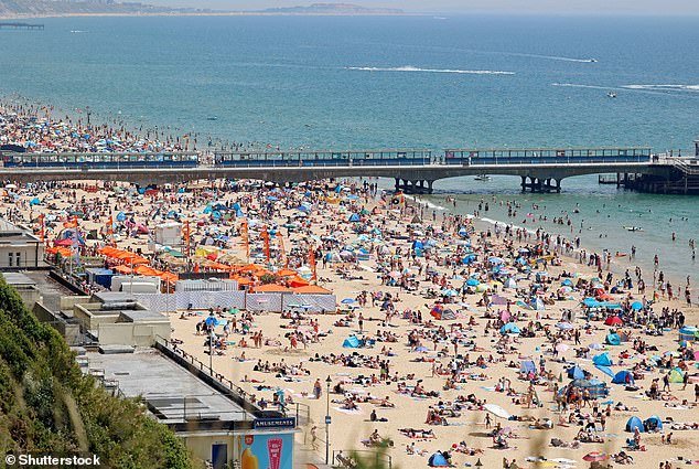 With heat-related deaths in the UK estimated at 3,496, a 10.28 per cent increase would take the true figure to 3,855 deaths over the summer.  Pictured: Bournemouth beach in June 2022