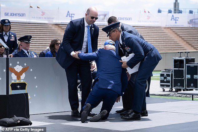 President Joe Biden is helped to his feet after a fall during the graduation ceremony at the United States Air Force Academy in Colorado in June.  He fell while handing out diplomas to cadets