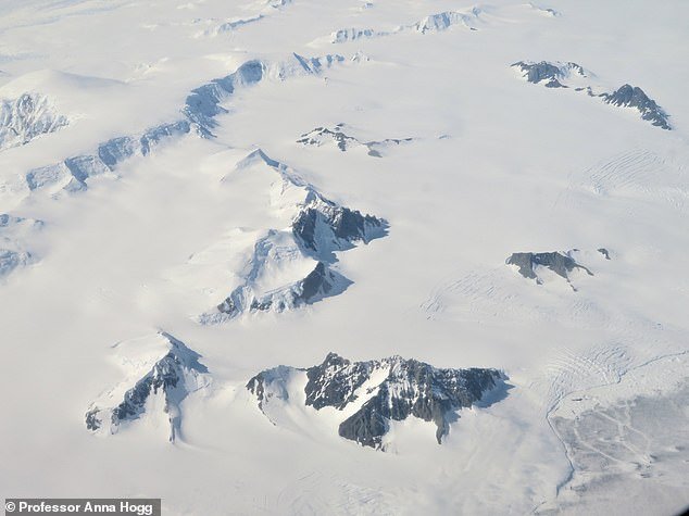 Experts rely on time-lapse cameras and satellites to show the movement of the glacial ice and how quickly it is moving.  Pictured are the mountains and glaciers of the Antarctic Peninsula from above
