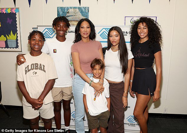 Simmons was pictured with her five children (L-R) Gary, Kenzo, Wolfe, Ming and Aoki last year - in Carson, California at a charity event