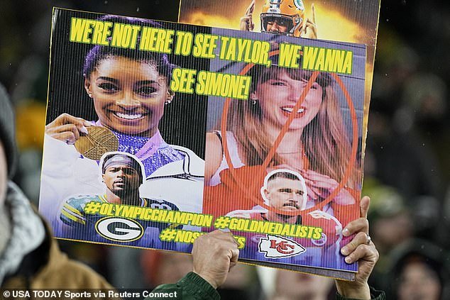 Some fans in Green Bay held up signs to show they were there to support Biles instead of Swift