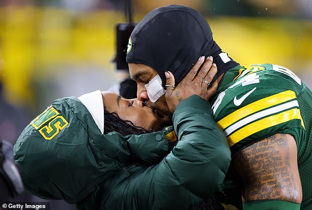 Olympic hero Biles kisses her husband Owens before Sunday night's win for the Packers