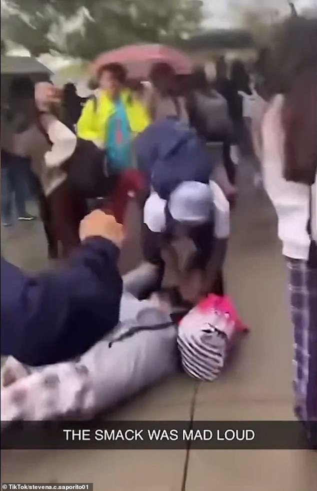 The victim lay helpless on the street as her attacker bombarded her with punches and kicks
