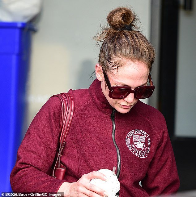 Lopez went makeup-free under huge sunglasses for her workout and scraped her natural brunette locks into a messy bun