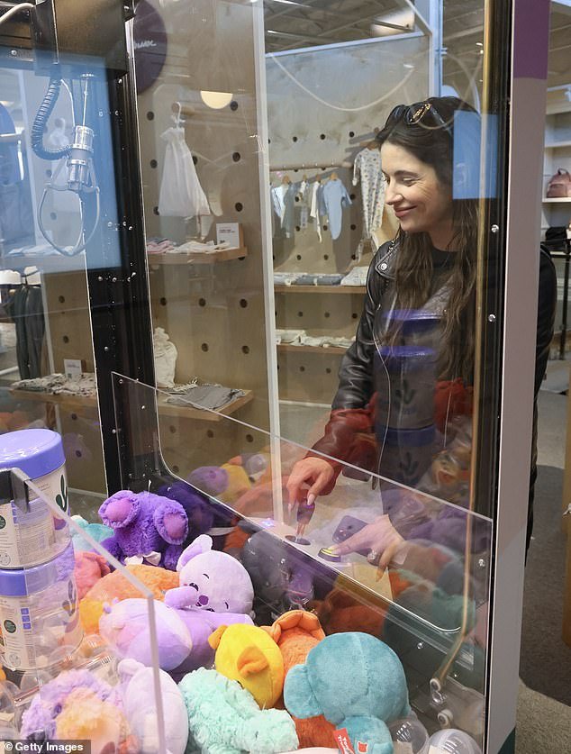 Ashley gets a closer look at baby toys during a visit to Babylist Beverly Hills Showroom and Shop on November 6