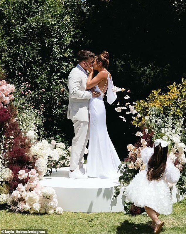Kayla and Jae exchanged vows on a stage surrounded by lush floral arrangements, surrounded by friends and family in their Adelaide home