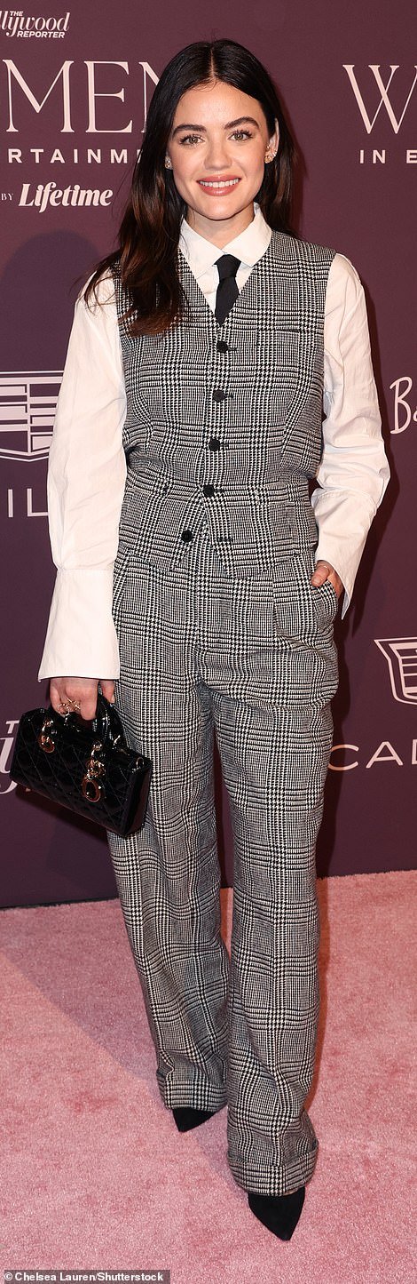 Lucy Hale opted for a black and white checked cardigan with matching trousers, with a white button-up and black tie underneath;  the Pretty Little Liars star carried a small patent black and silver handbag to match her pointy heels